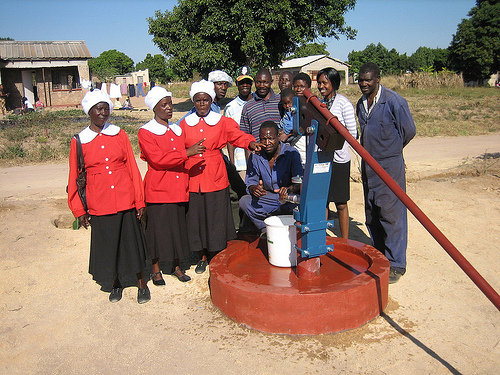 Residents admire their Bush Pump, in this case one fitted with extractable piston, making maintenance easier.: Photograph by PRM